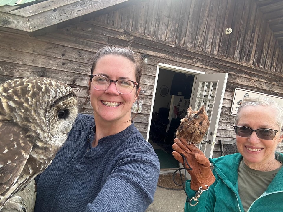 team members holding birds